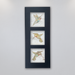 A trio of three different delicately coloured hummingbirds on beige porcelain tile mounted in a black anodized aluminum frame