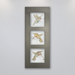 A trio of three different delicately coloured hummingbirds on beige porcelain tile mounted in a light bronze anodized aluminum frame