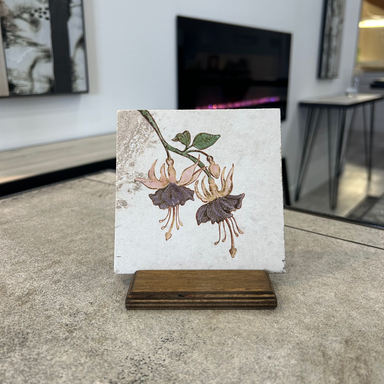 Fuchsia flowers on a beige porcelain tile displayed on a earth stained baltic birch stand