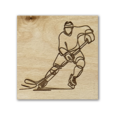 laser engraved image featuring a line drawing of a hockey player on a baltic birch tile
