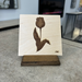 Laser engraved single tulip on natural baltic birch with a baltic birch display stand in dark brown